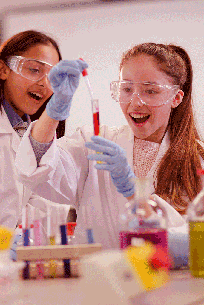 Teacher and student performing a chemistry experiment